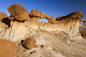 Chocolate Arch - brown rock arch sitting in a clay pan amidst Badlands Chocolate Arch - brown rock arch sitting in a clay pan amidst Badlands
