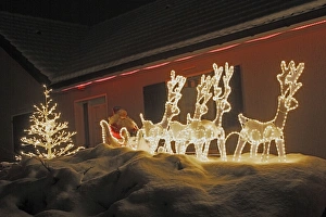 Images Dated 30th December 2005: Christmas Decorations - illuminated reindeer & sleigh outside house. France