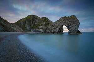 Wave Gallery: Colorful sky at dawn over Durdle Door along
