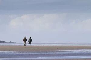 Couple walking on a deserted beach