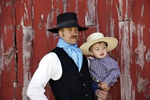 Cowboy carrying child