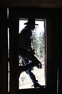Cowboy - silhouetted in door frame