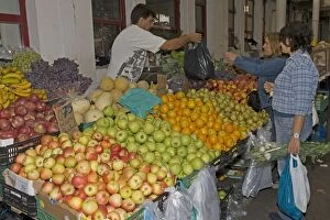 Apples Gallery: Cusomers buying fruit in market at Vila do Conde