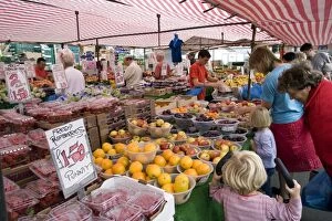 Customers buying fruit and vegetables at Saturday market