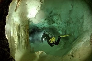 Diver with torch - Cave dving Maya Cenotes Yucatan Mexico