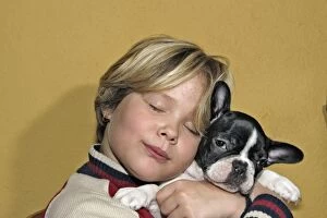 Images Dated 25th November 2004: Dog - Girl cuddling French Bulldog puppy