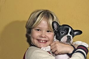 Images Dated 25th November 2004: Dog - Girl cuddling French Bulldog puppy