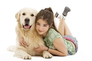 Images Dated 13th April 2000: Dog - Golden retriever lying in studio being cuddled by girl