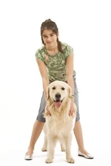 Dog - Golden retriever sitting in studio with girl