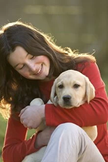 Images Dated 19th March 2005: Dog - Yellow Labrador Retriever puppy being held by girl