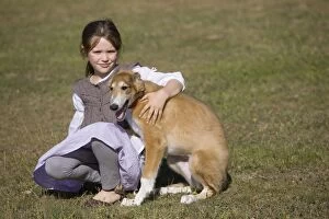 Dog - young girl cuddling Borzoi