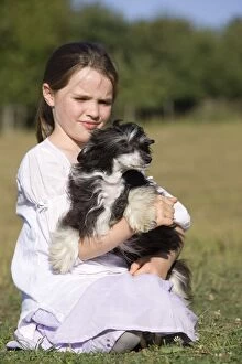 Dog - young girl cuddling dog