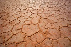 Dried-up earth - the hot sun in the Simpson Desert area blazes down onto the earth and dries it up until the soil cracks, creating an intricrate pattern - Rainbow Valley, Simpson Desert area, Northern Territory, Australia