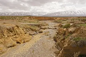 Drought Prints: Dry river on the Zeida plain, with the High Atlas mountains beyond; Morocco