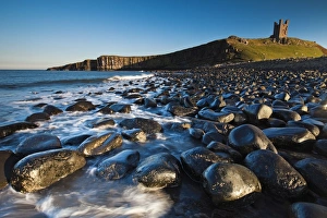 Images Dated 4th October 2010: Dunstanburgh Castle - and basalt boulder coastline north of castle