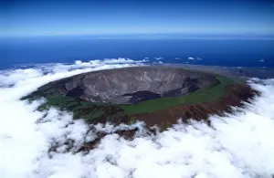 Ecuador Prints: Ecuador Galapagos Islands - Aerial view of Fernandina Island - Volcan Fernandina crater with low cloud in the garua
