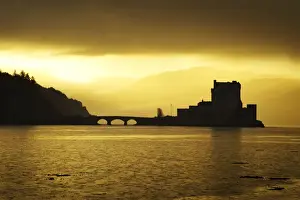 Scottish Prints: Eilean Donan Castle - being silhouetted in atmospheric conditions - November - Scotland