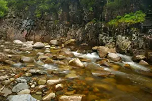 Etive river canyon water flowing over red rocks in riverbed with steep canyon walls Glen Etive, Glencoe area, Highlands, Scotland, UK