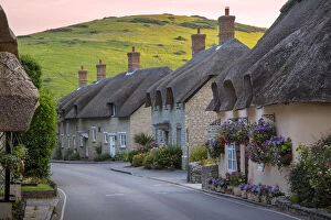 Evening view of thatch roof cottages in West Lulworth