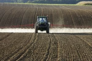 Farming - farmer spraying crops in tractor
