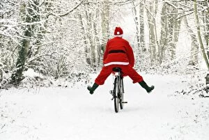 Images Dated 13th January 2010: Father Christmas - on a bicycle, freewheeling