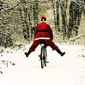 Images Dated 13th January 2010: Father Christmas - on a bicycle - freewheeling Digital Manipulation: enhanced colours