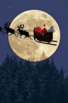 Father Christmas - flying on his bicycle past a