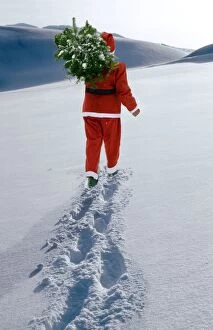 Father Christmas walking through winter landscape