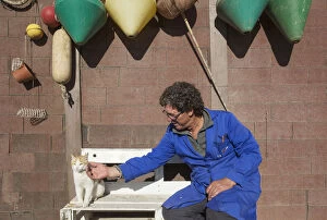 Fisherman and domestic cat at a fishermans cottage