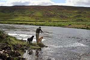 Fisherman - with hid dogs at river