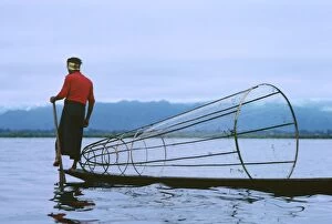 Fisherman on Inle Lake using fish trap