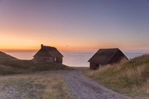 Fishing huts at the coast of Havaeng at sunrise - Sweden Fishing huts at the coast of Havaeng at sunrise - Sweden