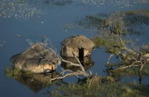 Disaster Prints: Flooded / Huts - Areial view of flooded huts Okavango delta, Botswana, Africa