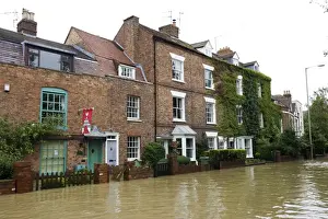 Gloucestershire Prints: Flooded road and houses opposite Tewkesbury Abbey Gloucestershire UK Level of Rivers Avon