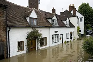 Roads Prints: Flooding - Baling water from flooded riverside cottages near Mythe Bridge Tewkesbury Gloucestershire UK Level of Rivers