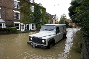 Gloucestershire Prints: Flooding - Landrover driving along flooded road near Tewkesbury Abbey Gloucestershire UK Level of Rivers Avon