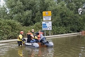 Flooding - Rescue team with people in inflatable