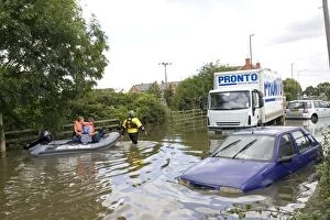 Flooding - rescue workers taking people in inflatable
