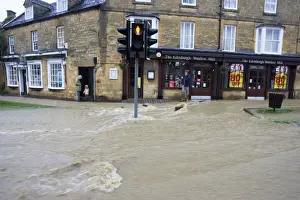 Road Prints: Floods - Torrents of flood water in high street Broadway Worcestershire UK July 21 2007