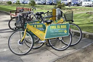 Transport Prints: Free to Ride OYB yellow bike rental docking station - Cheltenham Promenade Gloucestershire UK