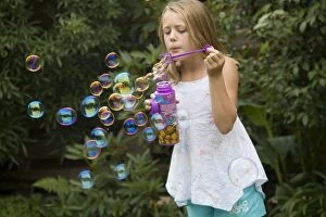 Images Dated 31st January 2006: Girl blowing bubbles