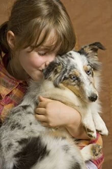 Girl - cuddling puppy