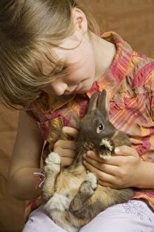 Images Dated 9th September 2007: Girl - cuddling rabbit