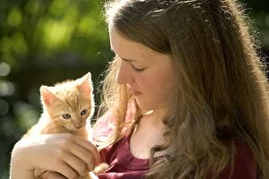 Images Dated 25th June 2005: Girl - holding ginger tabby kitten