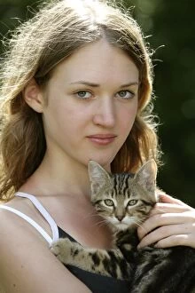 Girl holding Maine Coon kitten in hands