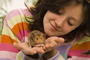 Child Gallery: Girl - holding pet Golden hamster