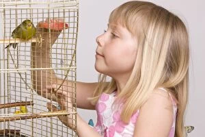 Cages Gallery: Girl with pet bird in cage