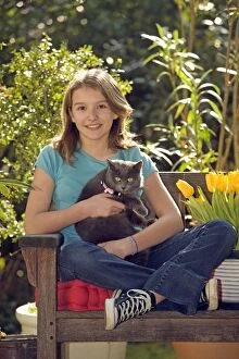 Child Gallery: Girl - sitting on bench in garden cuddling grey cat