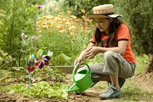 Girl - watering garden with watering can