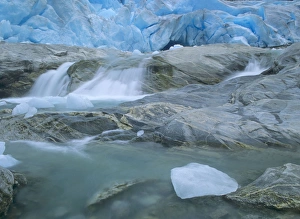 Glacier opening - blue glacier ice and glacial river at Nigardsbreen glacier